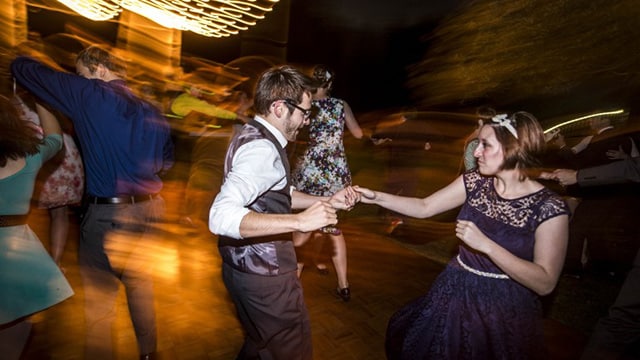 Students dancing in Slayton Arboretum at night.