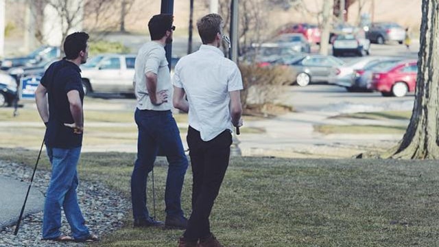 Students playing golf on campus.