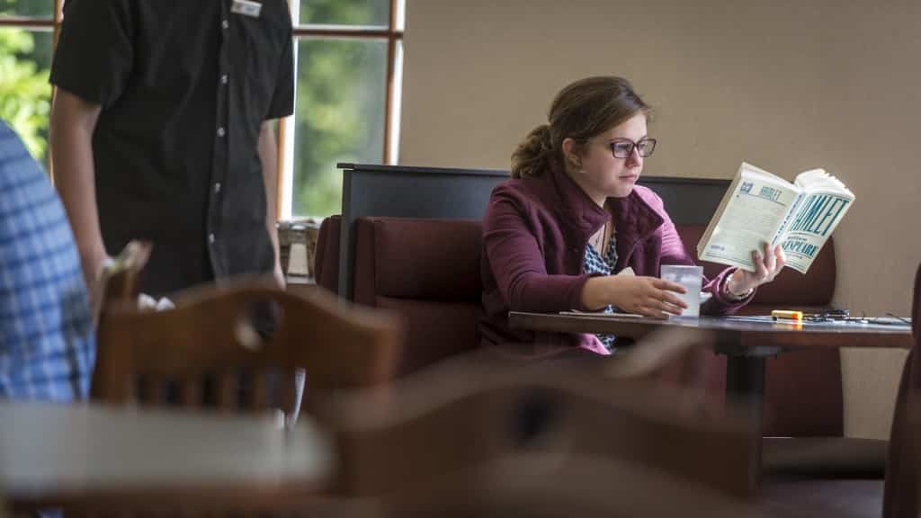 Student reading at lunch.