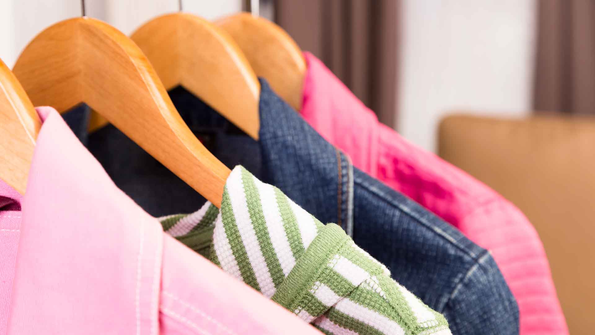 Several women's coats hanging up in Maribeth's boutique store.